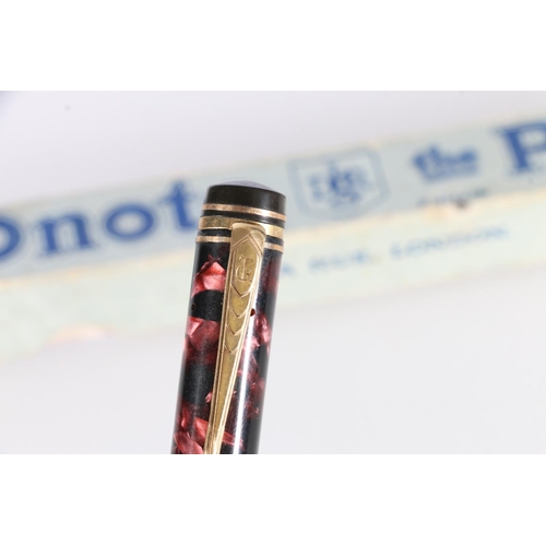 99 - De La Rue Onoto the Pen, plunger filling fountain pen with 14ct gold nib in red marble effect case, ... 