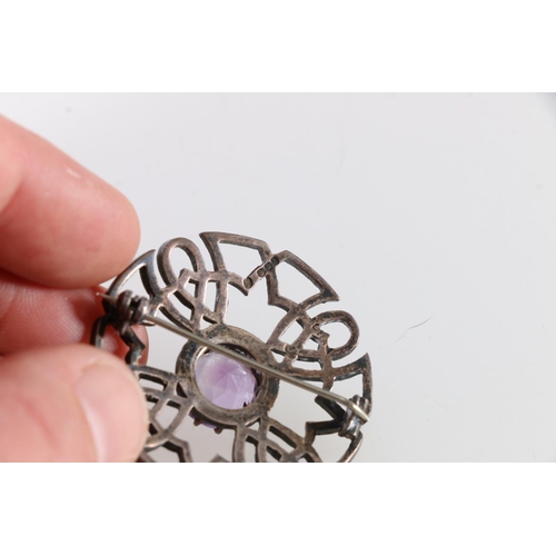 250 - Scottish silver openwork brooch of Celtic design, set with central faceted amethyst and a Scottish s... 