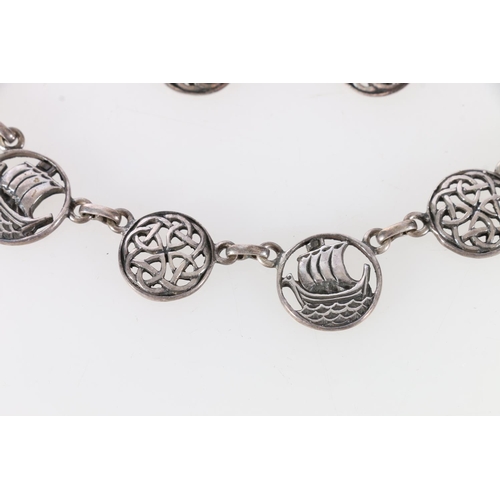 252 - Scottish silver necklace decorated with longboats and Celtic roundels, along with matching earrings,... 