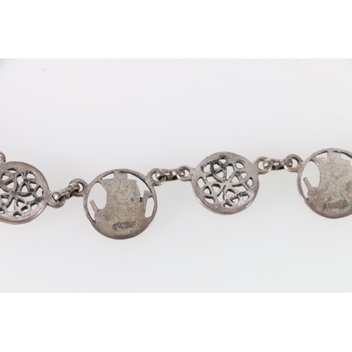 252 - Scottish silver necklace decorated with longboats and Celtic roundels, along with matching earrings,... 