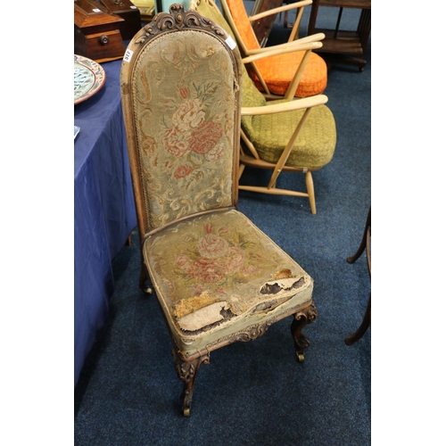 577 - Heavily carved Victorian mahogany high backed nursing chair with carved top rail, raised on brass ca... 