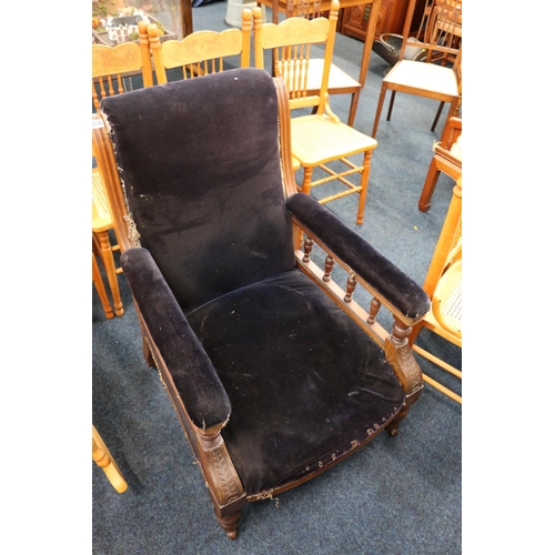 578 - Victorian mahogany carved armchair raised on turned supports upholstered in deep purple velvet.