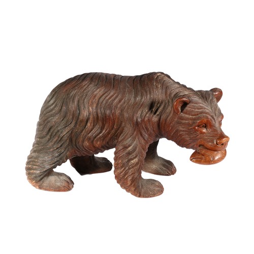 Black Forest style carved wood model of a bear with fish, 50cm long.