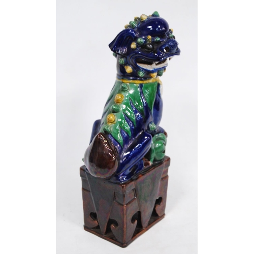 251 - Chinese pottery temple guardian (Dog of Fo), glazed in brown, yellow and green on a blue ground, fix... 