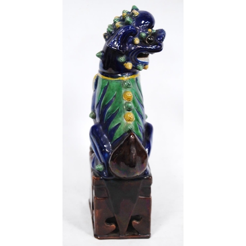 251 - Chinese pottery temple guardian (Dog of Fo), glazed in brown, yellow and green on a blue ground, fix... 