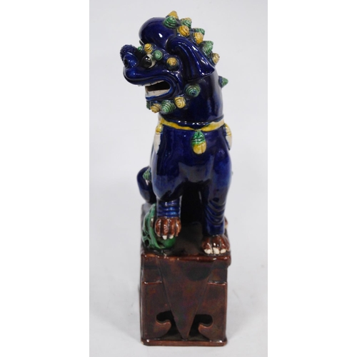 251 - Chinese pottery temple guardian (Dog of Fo), glazed in brown, yellow and green on a blue ground, fix... 