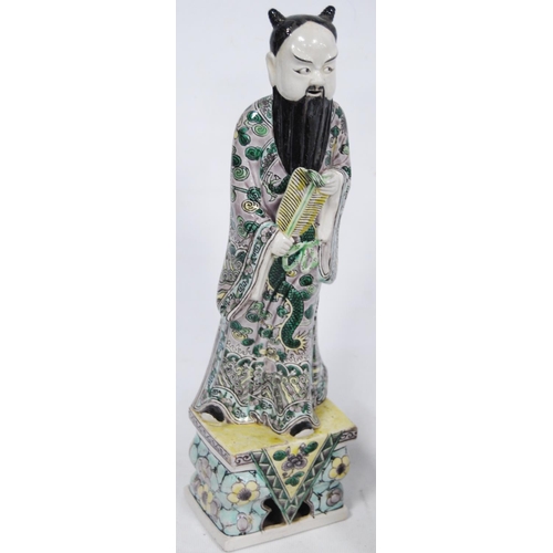 252 - Chinese famille verte pottery figure modelled as an Immortal, fixed to a famille rose base, 32.5cm h... 