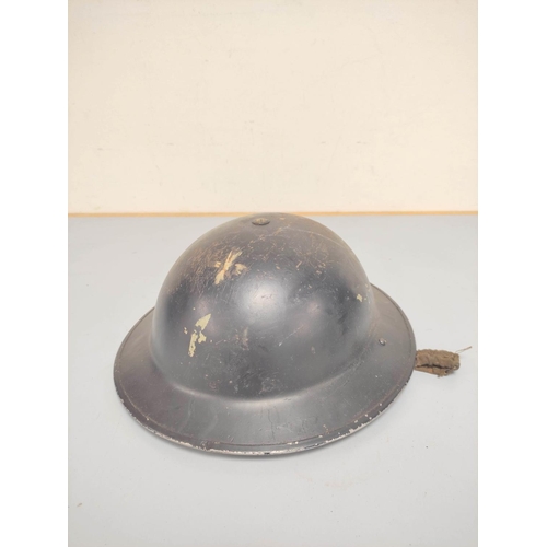 Three British military helmets comprising of a WW2 Brodie helmet