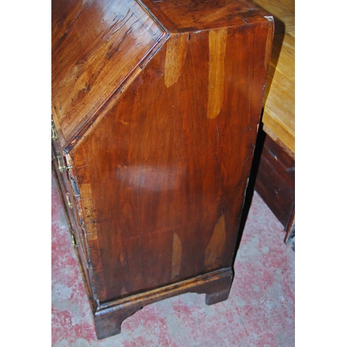 373 - Mid-18th century walnut bureau, the fall front enclosing drawers and pigeon holes, above four gradua... 