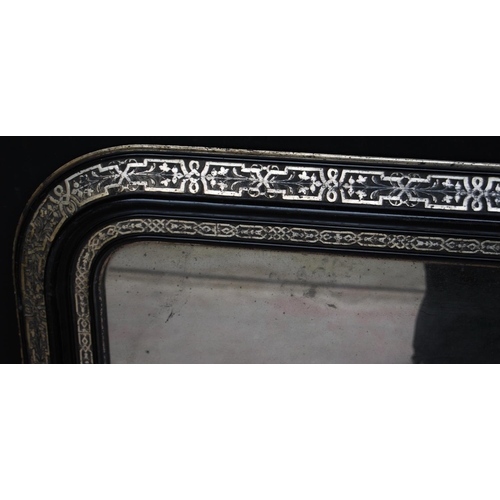 380 - Victorian ebonised overmantel mirror decorated with white metal foliate banding, 75cm high and 114cm... 