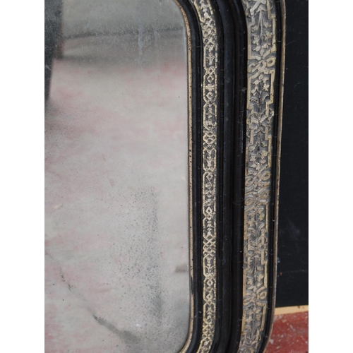 380 - Victorian ebonised overmantel mirror decorated with white metal foliate banding, 75cm high and 114cm... 