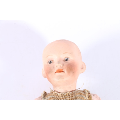 12 - German Heubach porcelain baby doll, the head stamped '8004', 20cm tall.