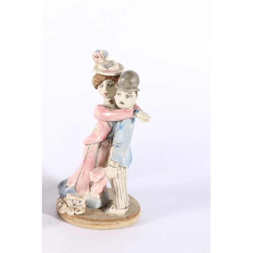 13 - Laura Dunn Studio Pottery figure groups of a husband and wife with cat, 13cm and 10cm tall.  (2)