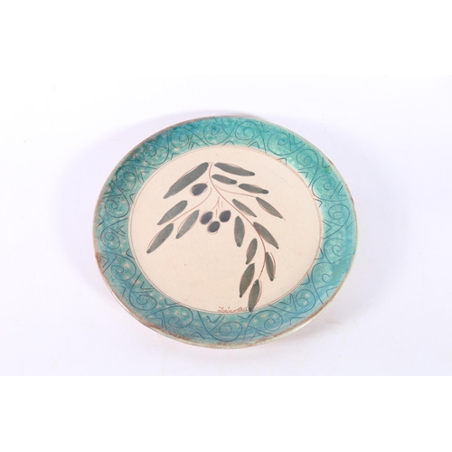 9 - Studio Pottery plate decorated with olive branch, 25cm diameter, signed.