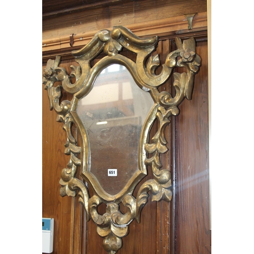 651 - Gilt framed ornate wall mirror, 57cm wide.