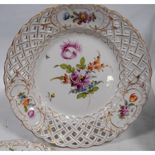 231 - Set of four continental porcelain fruit plates decorated with colourful floral sprays and pierced la... 