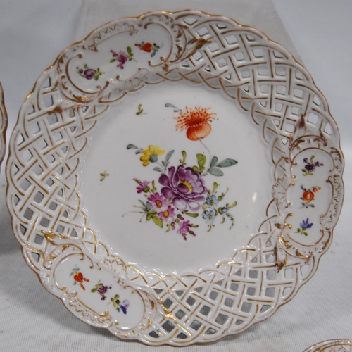 231 - Set of four continental porcelain fruit plates decorated with colourful floral sprays and pierced la... 