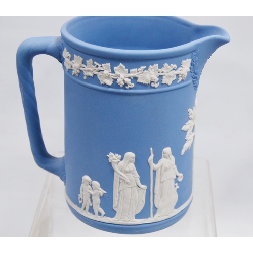 234 - Six pieces of Wedgwood blue Jasper ware comprising two jugs, two spill vases and a small planter, al... 