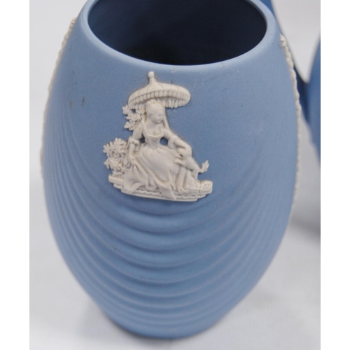 234 - Six pieces of Wedgwood blue Jasper ware comprising two jugs, two spill vases and a small planter, al... 