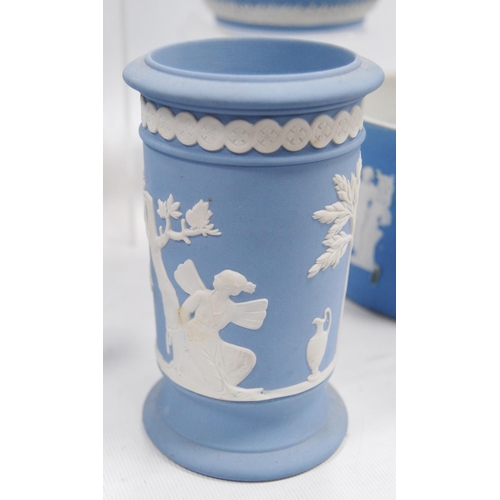 234 - Six pieces of Wedgwood blue Jasper ware comprising two jugs, two spill vases and a small planter, al... 