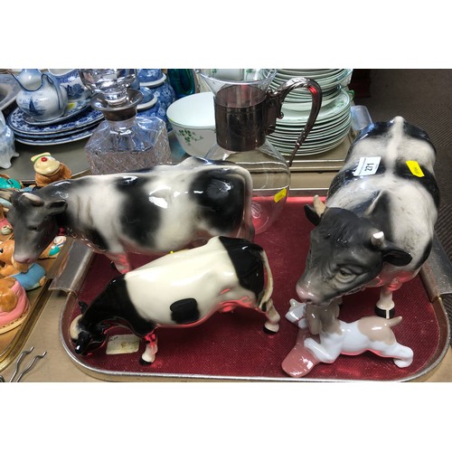 271 - Two Melba ware cows; one other; Nao figure and two silver plated mounted decanters