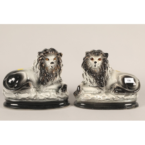 198 - Pair of Victorian Staffordshire seated lions; 22cm high