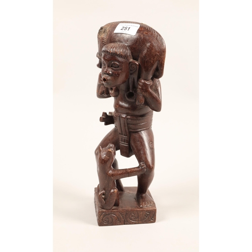 251 - Carved African figure of man with boar on his shoulders and dog at his feet