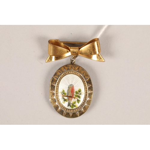 72 - Silver and enamel oval shaped locket / brooch; decorated with a bird