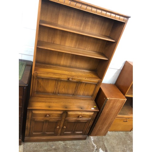 643 - Ercol floor standing bookcase and drinks cabinet raised on cupboard and plinth base