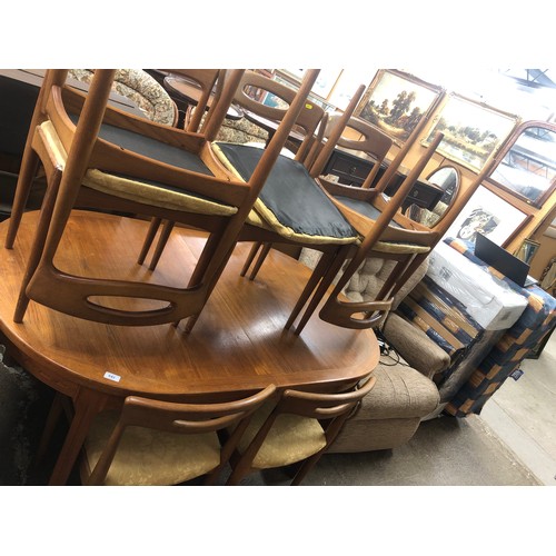 642 - Teak dining table with eight matching teak single chairs with two additional leaves