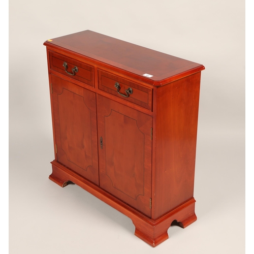 460 - Yew wood two door and two drawer sideboard on bracket feet