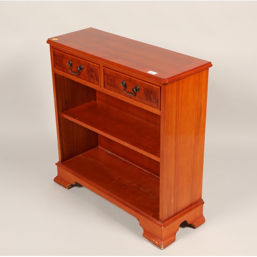 461 - Yew wood two drawer and shelf open bookcase on bracket feet