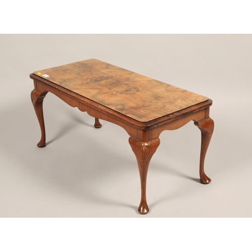 507 - Walnut veneered coffee table; raised on cabriole legs