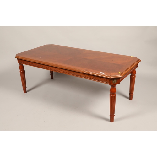 534 - Mahogany effect table raised on fluted legs