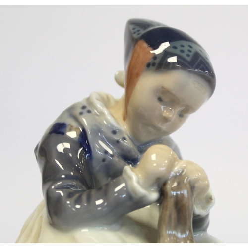 202 - Royal Copenhagen porcelain figure of a seated girl darning a sock, no. 1314, 1923 green underglaze m... 