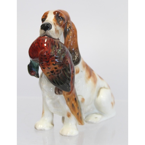 203 - Royal Doulton bone china figure of a seated spaniel holding a pheasant, HN1001, 17cm high.