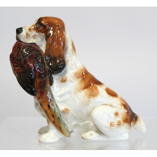 203 - Royal Doulton bone china figure of a seated spaniel holding a pheasant, HN1001, 17cm high.