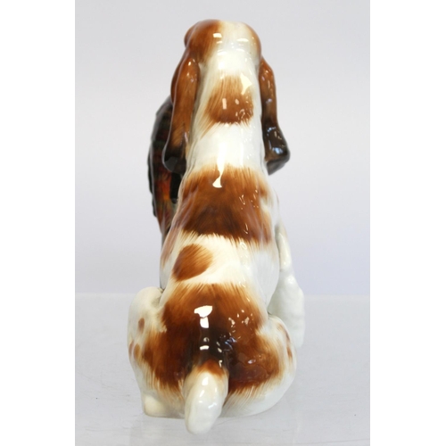 203 - Royal Doulton bone china figure of a seated spaniel holding a pheasant, HN1001, 17cm high.