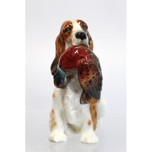 203 - Royal Doulton bone china figure of a seated spaniel holding a pheasant, HN1001, 17cm high.