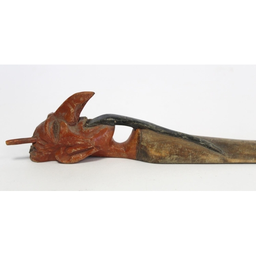 215 - Late 19th century Indian carved and stained wooden page turner, the handle in the form of a demon wi... 