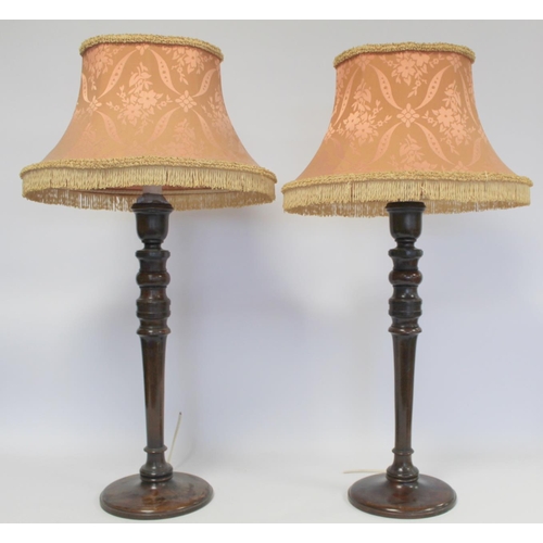 223 - Pair of turned mahogany table lamps, the columns each 53cm high. Electrical testing/rewiring require... 