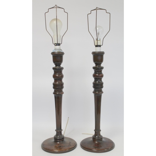 223 - Pair of turned mahogany table lamps, the columns each 53cm high. Electrical testing/rewiring require... 