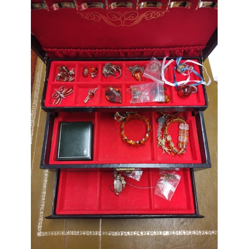 110 - Jewellery box containing miscellaneous costume jewellery to include amber-coloured bracelets, Scotti... 