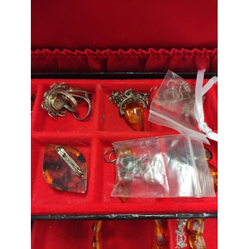 110 - Jewellery box containing miscellaneous costume jewellery to include amber-coloured bracelets, Scotti... 