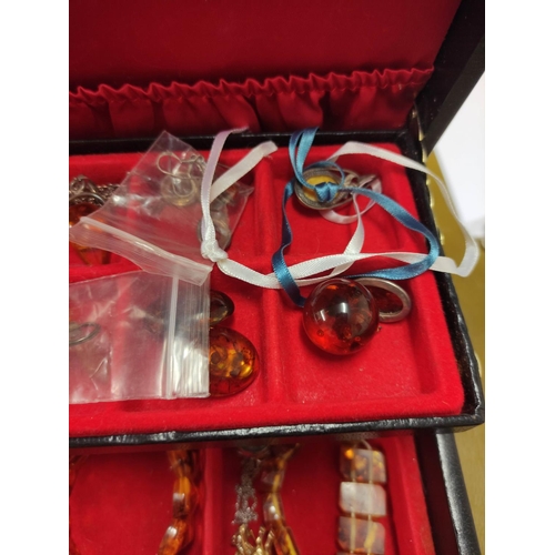 110 - Jewellery box containing miscellaneous costume jewellery to include amber-coloured bracelets, Scotti... 