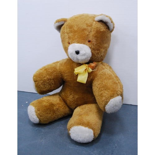 5 - Large teddy bear with yellow ribbon.