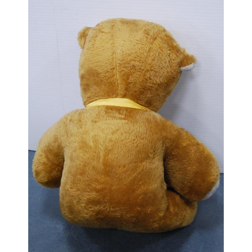 5 - Large teddy bear with yellow ribbon.