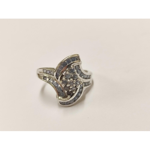 94 - 9ct gold lady's ring set with multiple blue-coloured stones, 4.6g gross.