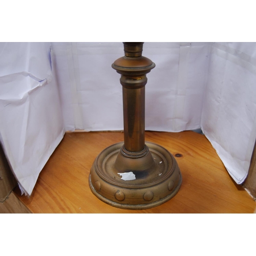 23 - Brass-mounted oil lamp with amber-coloured glass reservoir.