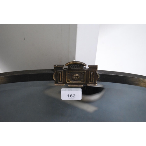 162 - White metal-mounted oval wall mirror.